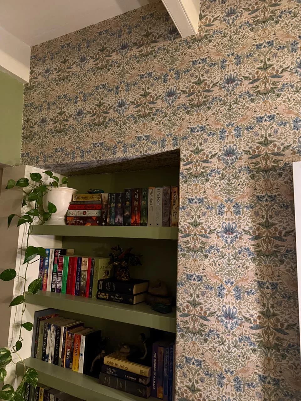 Riebeeck Kasteel interior with patterned wallpaper and painted built-in bookshelves
