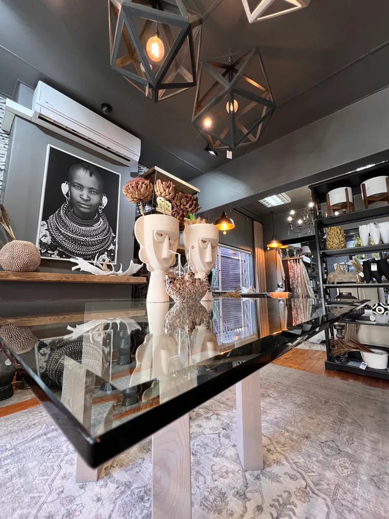 Glass table, lamps and decor objects in the showroom.