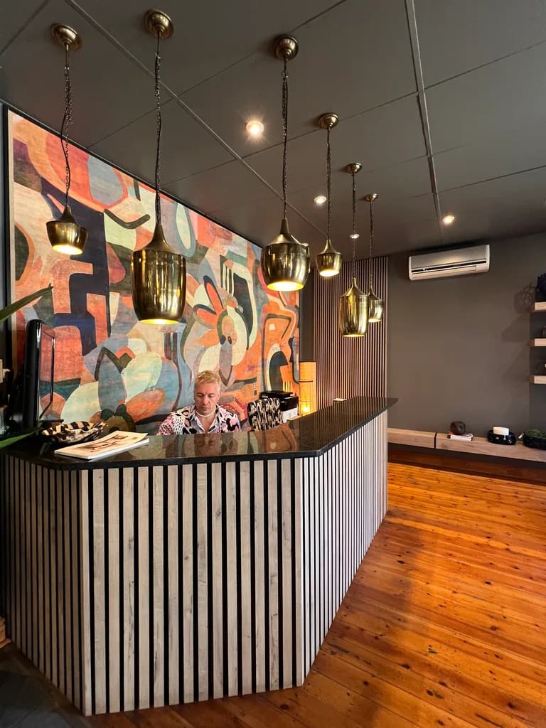 Free State Curtain Parlour reception counter with pendant lights and wallpaper.