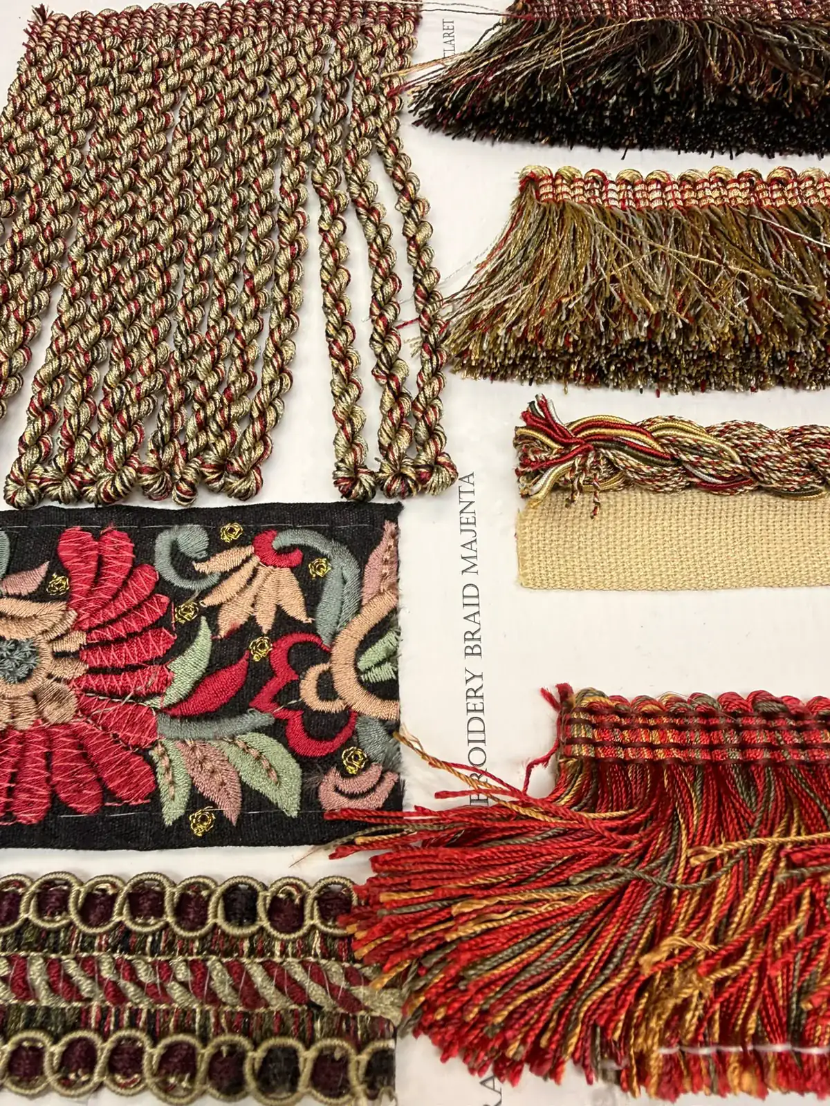 Decorative braids, fringes and trims arranged for selection.