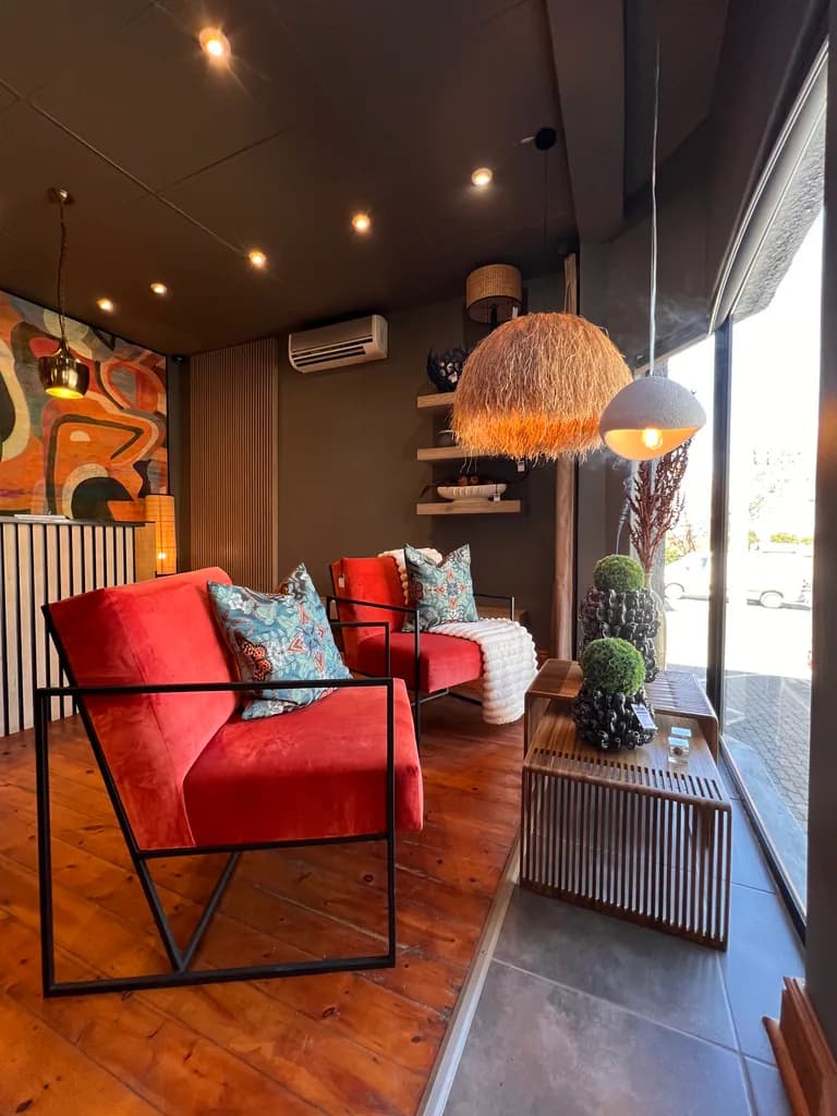 Red chairs, cushions and lighting in the showroom window area.