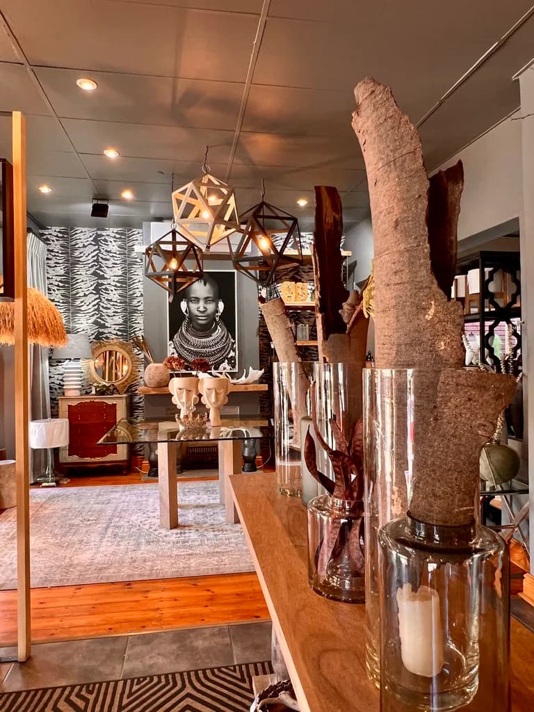 Showroom view with decorative vases, lighting and furniture.
