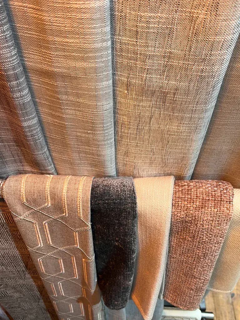 Close-up of textured fabrics and upholstery samples in the showroom.