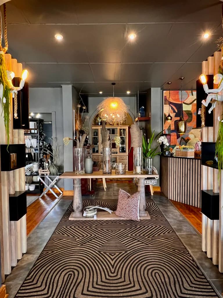 Main showroom view with decor shelving, rug and lighting.