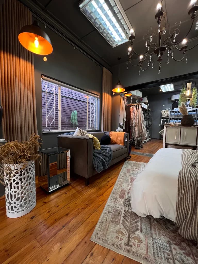 Room setting with curtains, sofa, cushions and lighting.