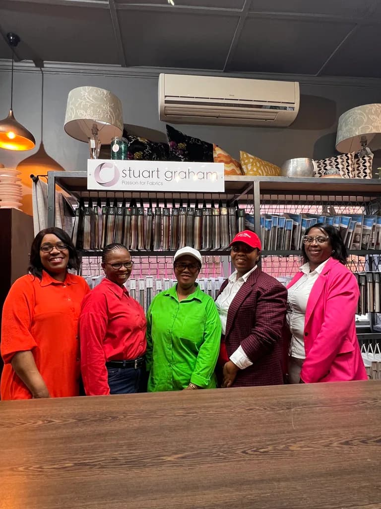 Free State Curtain Parlour workshop team standing in front of fabric sample displays